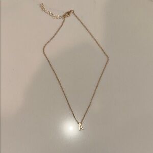 A Gold color Initial Necklace